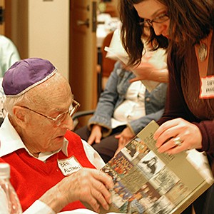 volunteer and survivor looking at a book