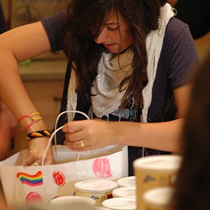 photo of young volunteer filling decorated holiday food bag