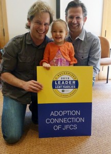 Adoptive dads, Michael and Mike, celebrate the HRC award with Adoption Connection and their daughter, Calliope. 
