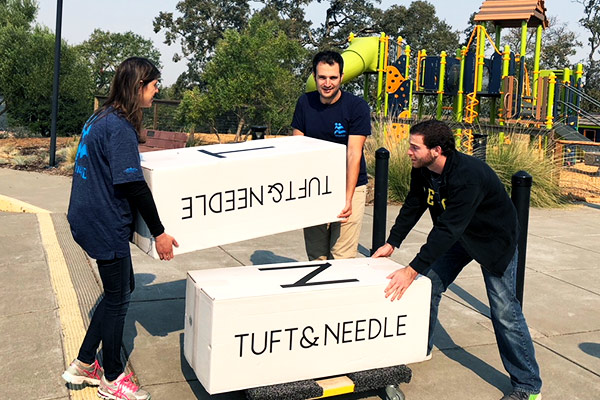 JFCS facilities staff and volunteers unpack new mattress delivered to Santa Rosa’s Congregation Shomrei Torah where evacuees are taking refuge.