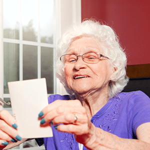 senior reading a card. 