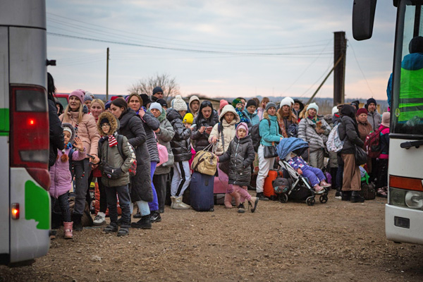 Newly-arrived Ukrainian refugees wait to board buses at the Palanca Border Crossing in Moldova.