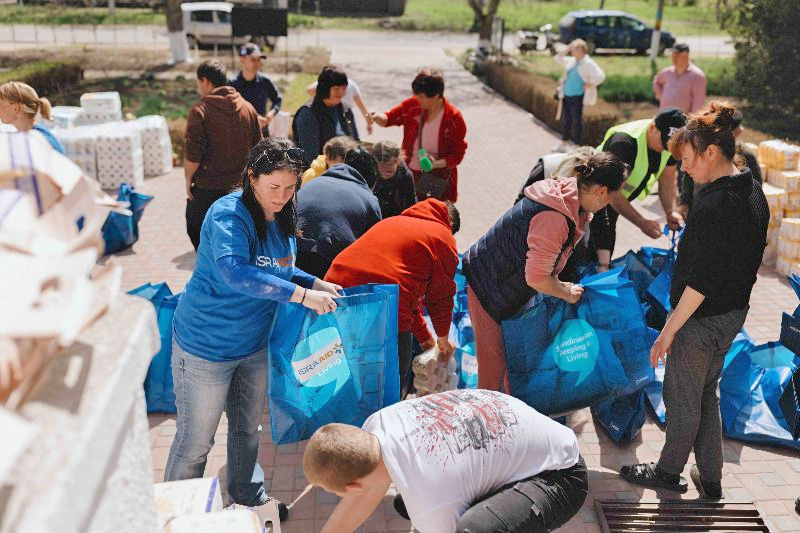 Volunteers and staff work together to unload essential supplies, which are provided thanks to donations from supporters like you. 