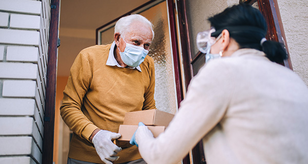 Senior receiving food delivery