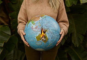 woman holding burning globe