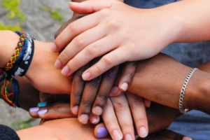 Teens' hands in a circle