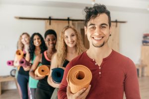 people with yoga mats
