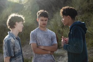 group of teens having a difficult conversation in a field