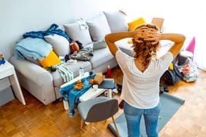 person looking at cluttered room