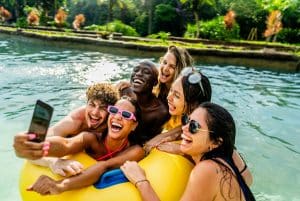people enjoying time in pool, taking a selfie