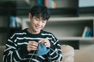 man knitting