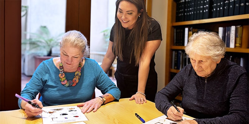The social aspect to JFCS’ Mind Sharpener program is a bonus. Pictured: Andrea Korsunsky, Seniors At Home, with participants in a recent workshop.