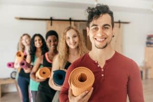 people holding yoga mats