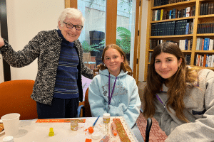 Some teen volunteers with a senior, all smiling