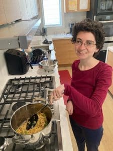 Betty prepares a meal on the stovetop at Ady's Place.